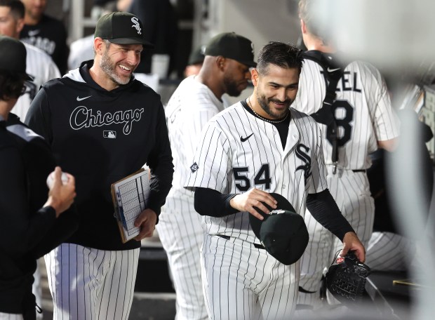 Chicago White Sox starting pitcher Martín Pérez (54) has a laugh with pitching coach Ethan Katz after Pérez shut down the Kansas City Royals in the fifth inning of a game at Rate Field in Chicago on Aug. 26, 2025. (Chris Sweda/Chicago Tribune)