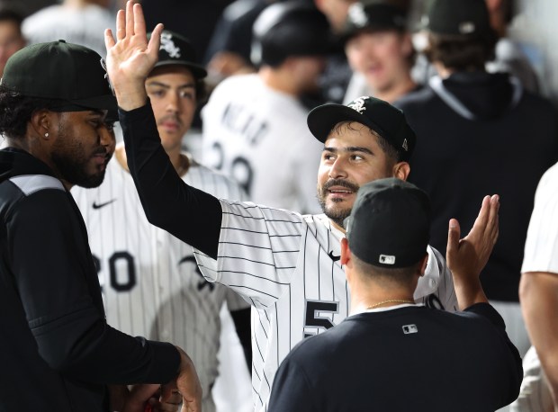 Chicago White Sox starting pitcher Martín Pérez receives high-fives in the dugout after shutting down the Kansas City Royals in the seventh inning of a game at Rate Field in Chicago on Aug. 26, 2025. (Chris Sweda/Chicago Tribune)