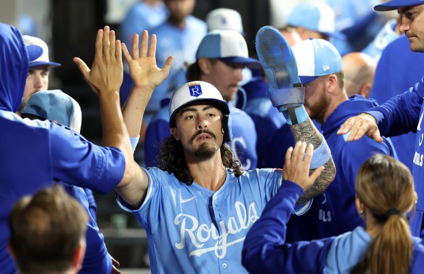 Kansas City Royals second baseman Jonathan India is congratulated by his teammates in the dugout after scoring on a single by Kyle Isbel in the ninth inning of a game against the Chicago White Sox at Rate Field in Chicago on Aug. 26, 2025. (Chris Sweda/Chicago Tribune)