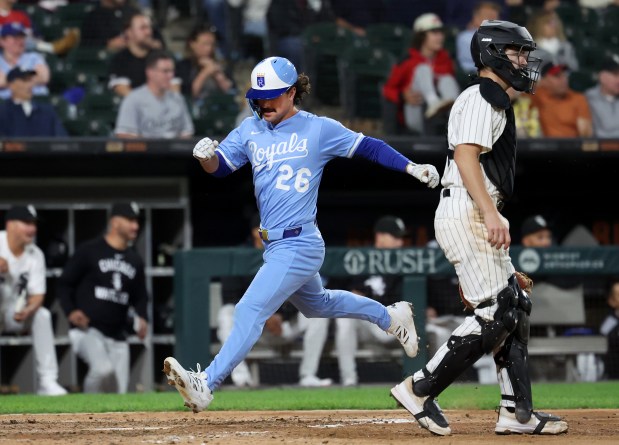 Kansas City Royals designated hitter Adam Frazier (26) scores a run on a 2-run single by teammate Maikel Garcia in the eighth inning of a game against the Chicago White Sox at Rate Field in Chicago on Aug. 26, 2025. (Chris Sweda/Chicago Tribune)