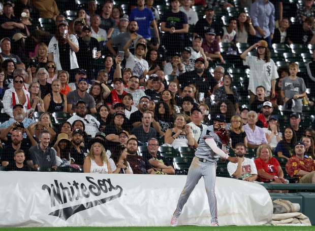 After making a catch of a pop foul, Minnesota Twins third base Royce Lewis throws home before Chicago White Sox third baseman Miguel Vargas was tagged out at home plate   by catcher Ryan Jeffers to end the eighth inning at Rate Field in Chicago on Aug. 22, 2025.  (Chris Sweda/Chicago Tribune)