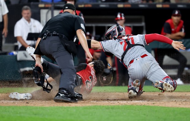 Minnesota Twins catcher Ryan Jeffers tags out Chicago White Sox third baseman Miguel Vargas at home plate as Vargas tried to score after a pop foul to end the eighth inning at Rate Field in Chicago on Aug. 22, 2025.  (Chris Sweda/Chicago Tribune)