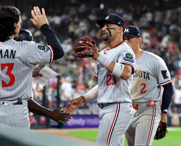 Minnesota Twins third baseman Royce Lewis is congratulated by his teammates after throwing out Chicago White Sox third baseman Miguel Vargas at home plate to end the eighth inning at Rate Field in Chicago on Aug. 22, 2025.  (Chris Sweda/Chicago Tribune)