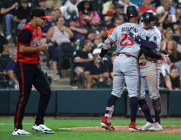 Twins shortstop Brooks Lee is congratulated by teammate Byron Buxton (25) after Lee scored in the seventh inning against the White Sox on Aug. 22, 2025, at Rate Field. (Chris Sweda/Chicago Tribune)