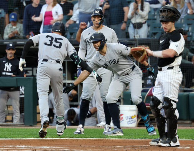 New York Yankees left fielder Cody Bellinger (35) is congratulated by teammates Giancarlo Stanton and Aaron Judge (top) after Bellinger hit a two-run home run in the first inning of a game against the Chicago White Sox at Rate Field in Chicago on Aug. 28, 2025. (Chris Sweda/Chicago Tribune)
