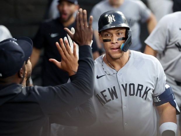 New York Yankees designated hitter Aaron Judge is congratulated by his teammates in the dugout after hitting a solo home run in the fourth inning of a game against the Chicago White Sox at Rate Field in Chicago on Aug. 30, 2025. (Chris Sweda/Chicago Tribune)