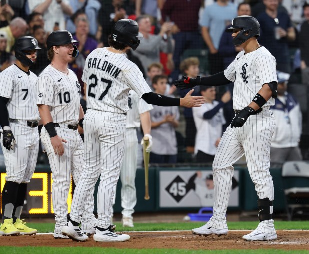 Chicago White Sox first baseman Miguel Vargas is congratulated by his teammates as he crosses home plate after hitting a grand slam in the second inning of a game against the New York Yankees at Rate Field in Chicago on Aug. 28, 2025. (Chris Sweda/Chicago Tribune)