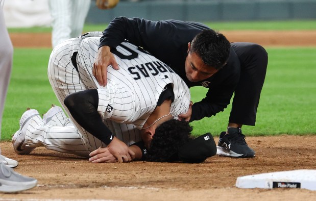 Chicago White Sox first baseman Miguel Vargas receives medical attention after suffering an injury in the fifth inning of a game against the New York Yankees at Rate Field in Chicago on Aug. 28, 2025. (Chris Sweda/Chicago Tribune)