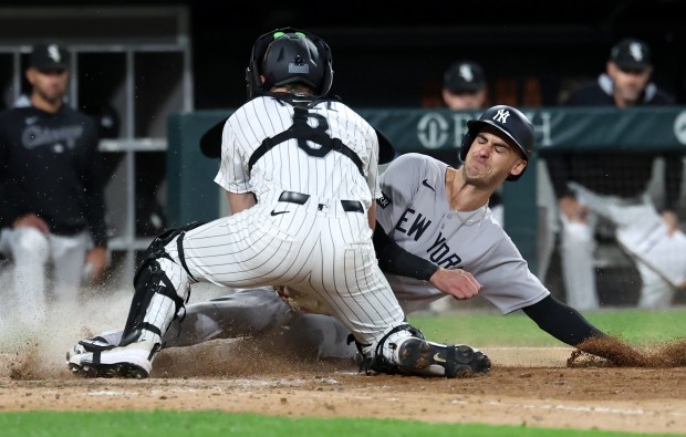 Chicago White Sox catcher Kyle Teel tags out New York Yankees left fielder Cody Bellinger at home plate in the 11th inning of a game at Rate Field in Chicago on Aug. 30, 2025. (Chris Sweda/Chicago Tribune)