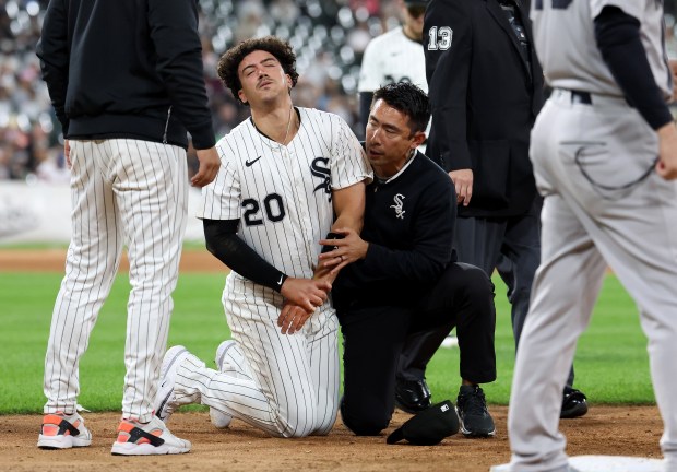 Chicago White Sox first baseman Miguel Vargas receives medical attention after suffering an injury in the fifth inning of a game against the New York Yankees at Rate Field in Chicago on Aug. 28, 2025. (Chris Sweda/Chicago Tribune)