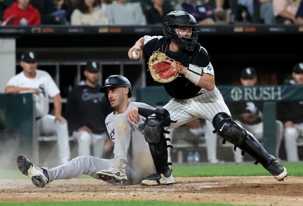 Chicago White Sox catcher Kyle Teel checks the baserunners after tagging out New York Yankees left fielder Cody Bellinger at home plate in the 11th inning of a game at Rate Field in Chicago on Aug. 30, 2025. (Chris Sweda/Chicago Tribune)