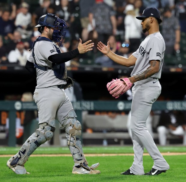 New York Yankees catcher Austin Wells and relief pitcher Camilo Doval celebrate after a victory over the Chicago White Sox at Rate Field in Chicago on Aug. 30, 2025. (Chris Sweda/Chicago Tribune)