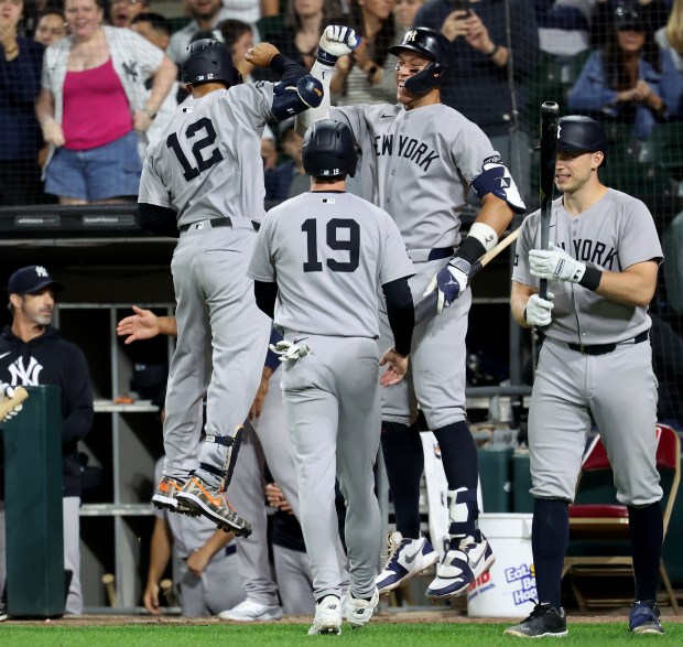 New York Yankees center fielder Trent Grisham (12) is congratulated by teammate Aaron Judge after Grisham hit a two-run home run in the eighth inning of a game against the Chicago White Sox at Rate Field in Chicago on Aug. 28, 2025. (Chris Sweda/Chicago Tribune)