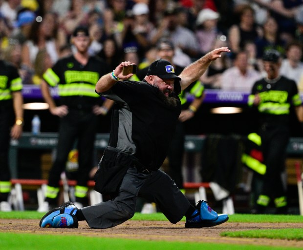 The plate umpire dances during the game between the Savannah Bananas and the Firefighters at Coors Field on Saturday, Aug. 09, 2025, in Denver. (Andy Cross/Denver Post)