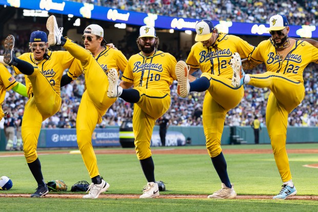 The Savannah Bananas perform a kick line before taking on the Firefighters at Angel Stadium on May 30, 2025, in Anaheim, Calif. (Luke Johnson/Los Angeles Times)