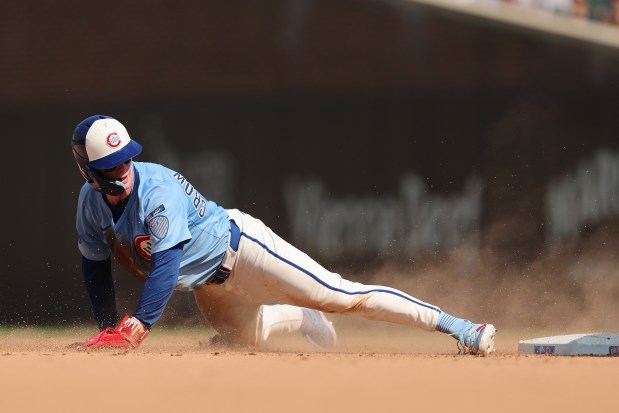Cubs center fielder Pete Crow-Armstrong slides past second base on a steal attempt during the ninth inning against the Pirates on Aug. 15, 2025, at Wrigley Field. Armstrong was tagged out on the play. (Michael Reaves/Getty Images)