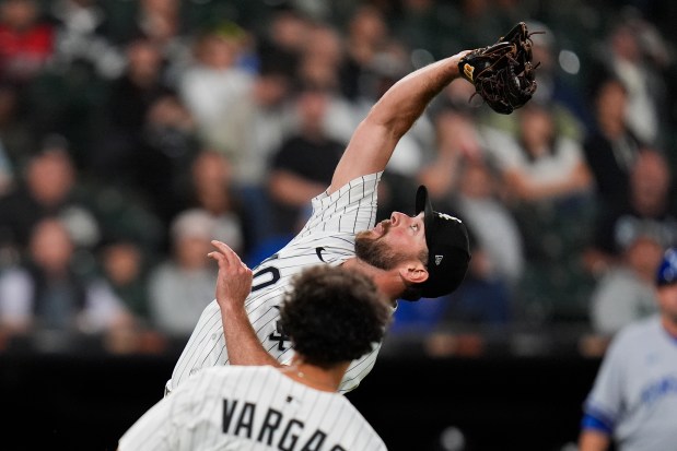 Chicago White Sox pitcher Tyler Gilbert, top, catches a popouthit by Kansas City Royals' Vinnie Pasquantino (not shown) to end baseball game Monday, Aug. 25, 2025, in Chicago. (AP Photo/Erin Hooley)