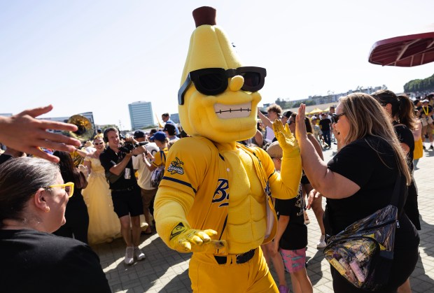 Savannah Bananas mascot Split marches through the crowd as fans are let into Angel Stadium on May 30, 2025, in Anaheim, Calif. (Luke Johnson/Los Angeles Times)