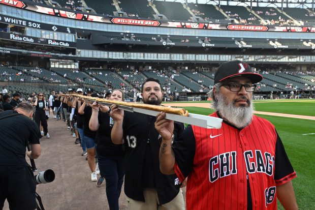 A 50-foot hot dog is paraded around the field before a White Sox-Guardians game on Saturday, Aug. 9, 2025, at Rate Field. (Paul Beaty/AP)