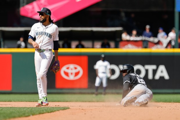 White Sox center fielder Luis Robert Jr. steals second base against behind Mariners shortstop J.P. Crawford during the seventh inning on Aug. 7, 2025, in Seattle. (Alika Jenner/Getty Images)