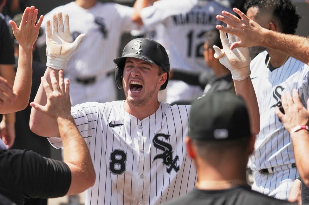 Chicago White Sox's Kyle Teel celebrates with teammates after scoring on a two-run single by Edgar Quero during the first inning of a baseball game against the Minnesota Twins in Chicago, Sunday, Aug. 24, 2025. (AP Photo/Nam Y. Huh)