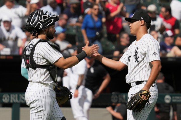 Chicago White Sox catcher Edgar Quero, left, celebrates with relief pitcher Wikelman González, right, after their team defeated the Minnesota Twins in a baseball game in Chicago, Sunday, Aug. 24, 2025. (AP Photo/Nam Y. Huh)