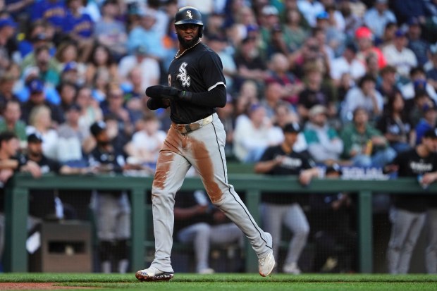 Chicago White Sox's Luis Robert Jr. scores on an RBI single from Curtis Mead against the Seattle Mariners during the second inning of a baseball game Wednesday, Aug. 6, 2025, in Seattle. (AP Photo/Lindsey Wasson)