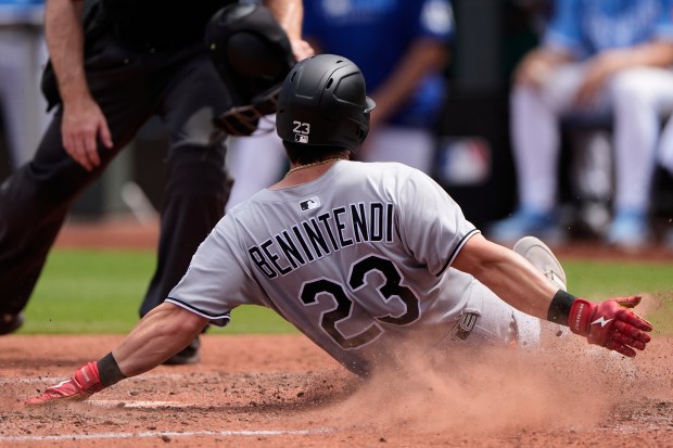 Chicago White Sox's Andrew Benintendi slides home to score on a single by Edgar Quero during the sixth inning of a baseball game against the Kansas City Royals, Sunday, Aug. 17, 2025, in Kansas City, Mo. (AP Photo/Charlie Riedel)