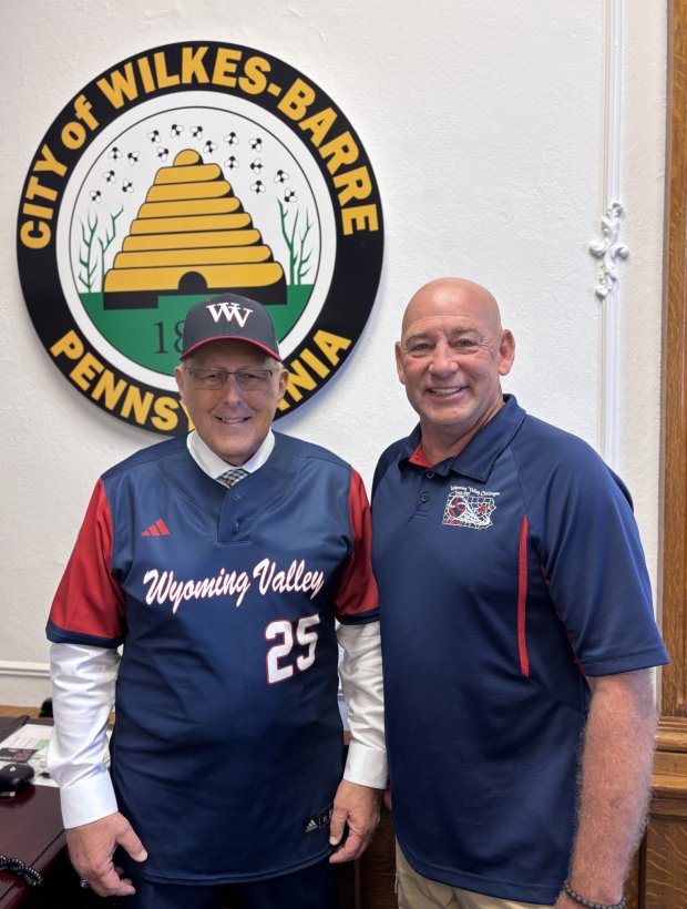 Wilkes-Barre City Mayor George C. Brown, left, shows off his personalized baseball jersey from the Wyoming Valley Challenger Baseball Little League President Larry Wills. SUBMITTED