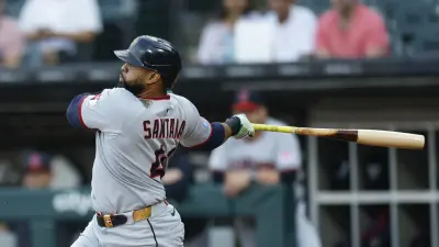 Aug 8, 2025; Chicago, Illinois, USA; Cleveland Guardians first baseman Carlos Santana (41) hits a two-run double against the Chicago White Sox during the first inning at Rate Field.