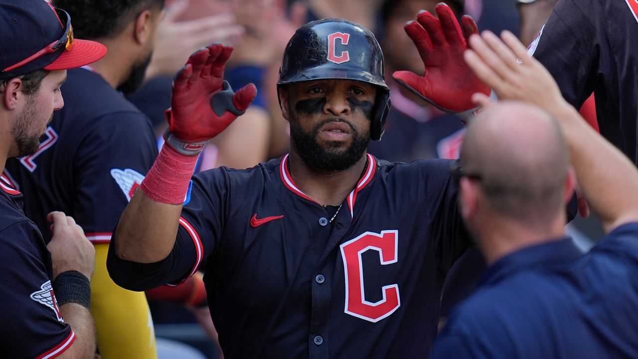 Cleveland Guardians' Carlos Santana celebrates after hitting a two-run home run during the sixth inning of the first baseball game of a doubleheader against the Chicago White Sox, Friday, July 11, 2025, in Chicago.