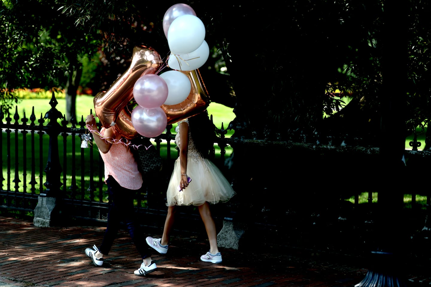 People walked with balloons in the afternoon sun near the Boston Public Garden on July 26.