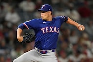 Texas Rangers relief pitcher Robert Garcia throws to the plate during the ninth inning of a...