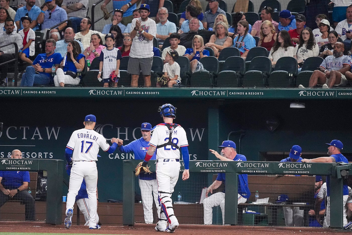 Texas Rangers pitcher Nathan Eovaldi gets a hand as he leave the field after pitching the...