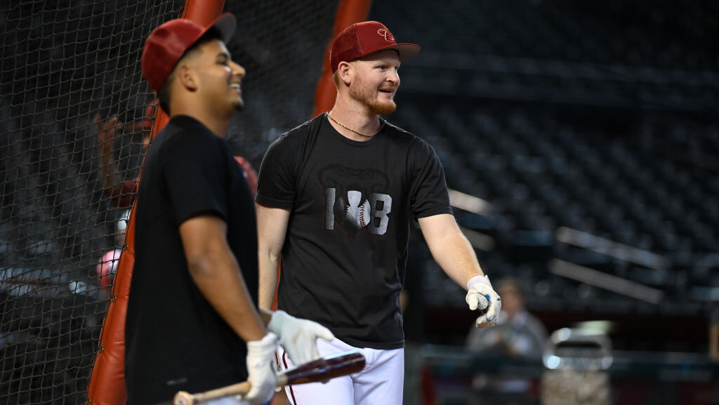 Gabriel Moreno #14 and Pavin Smith #26 of the Arizona Diamondbacks...