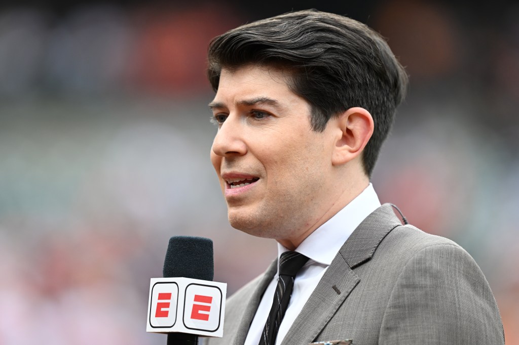 A reporter speaking into a microphone.