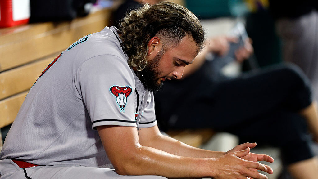 Relief pitcher Juan Morillo #67 of the Arizona Diamondbacks reacts in the dugout after going up fou...