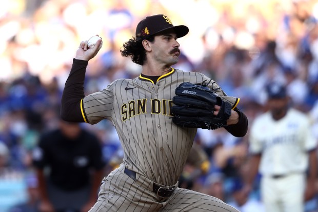 San Diego Padres starting pitcher Dylan Cease throws to the...