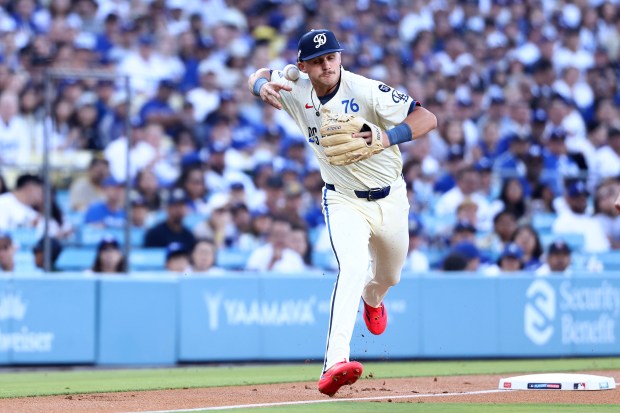 Dodgers third baseman Alex Freeland bobbles the ball while attempting...