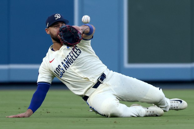 Dodgers left fielder Michael Conforto makes a sliding catch in...