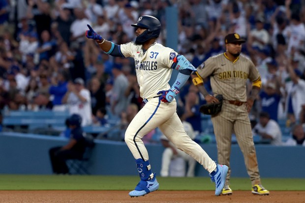 The Dodgers’ Teoscar Hernández celebrates as he runs the bases...