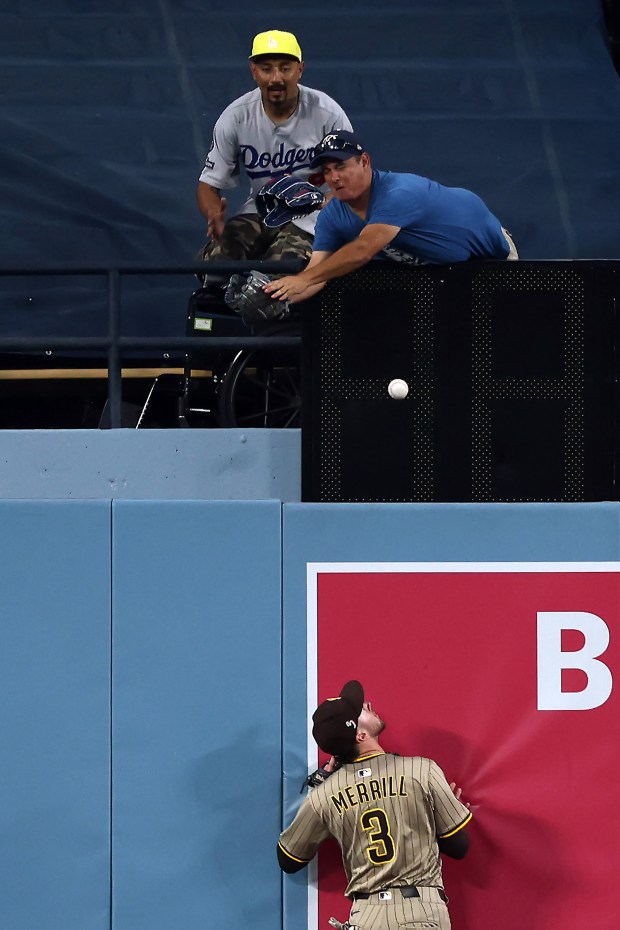 San Diego Padres outfielder Jackson Merrill watches as a fan...