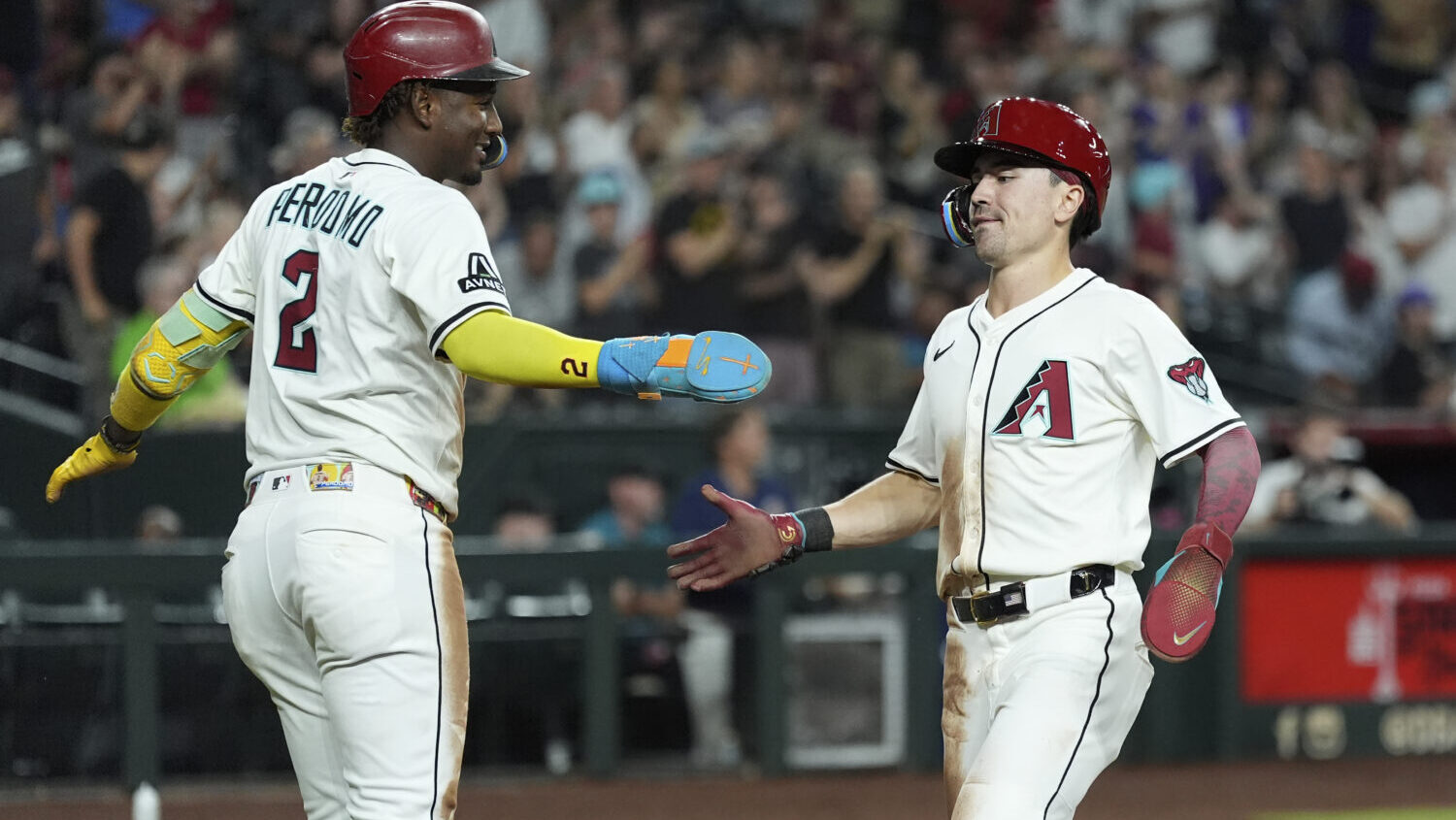 Arizona Diamondbacks' Geraldo Perdomo (2) and Corbin Carroll...