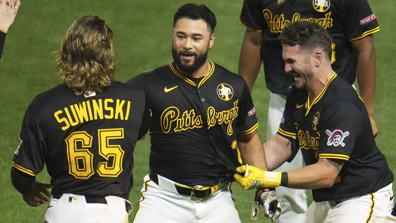 Pittsburgh shortstop Isiah Kiner-Falefa, center, celebrated with Jack Suwinski (65) and Spencer Horwitz, right, after driving in a walk-off run with a fielder's choice against the San Francisco Giants on Monday.