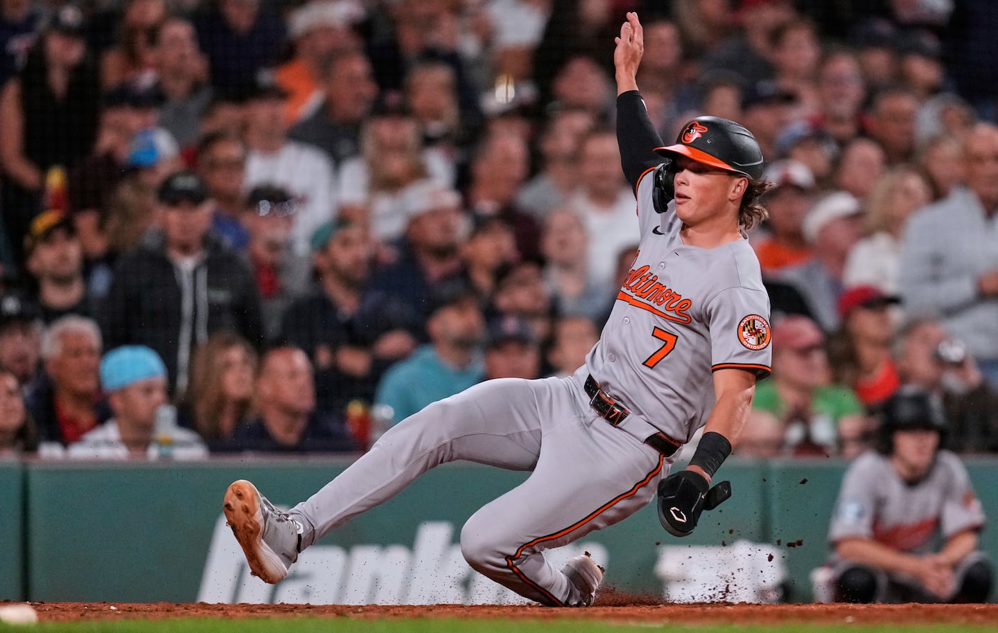 Jackson Holliday slides into base at Fenway Park, where he faced his old friend Roman Anthony.