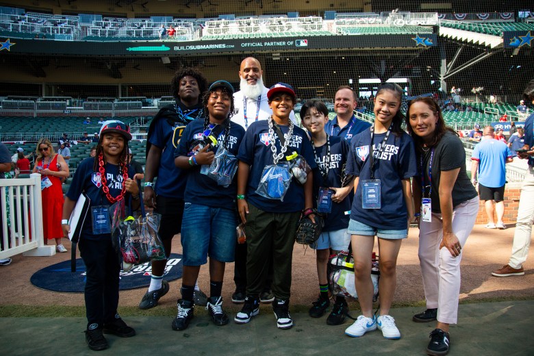 Jeremiah Hindsman (with the Miami Marlins necklace third from left), Jayvion Dickerson (second from the left), and Amy Hever (right) with STEM League participants (Photo courtesy MLBPA).
