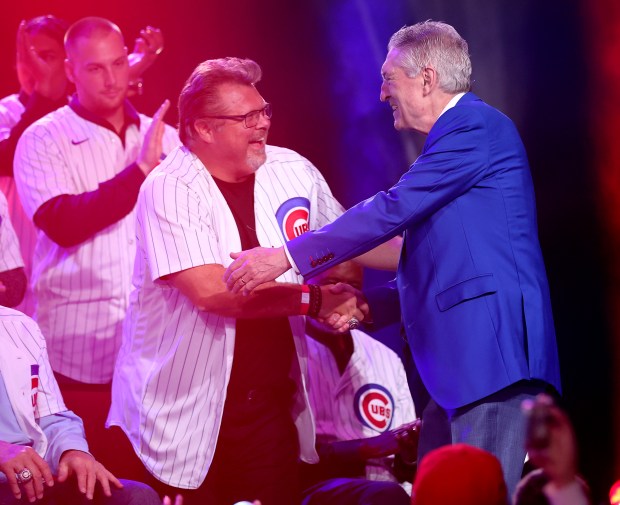 Cubs radio announcers Ron Coomer, left, and Pat Hughes embrace on stage during the opening ceremony of the Cubs Convention on Jan. 12, 2024, at the Sheraton Grand Chicago.