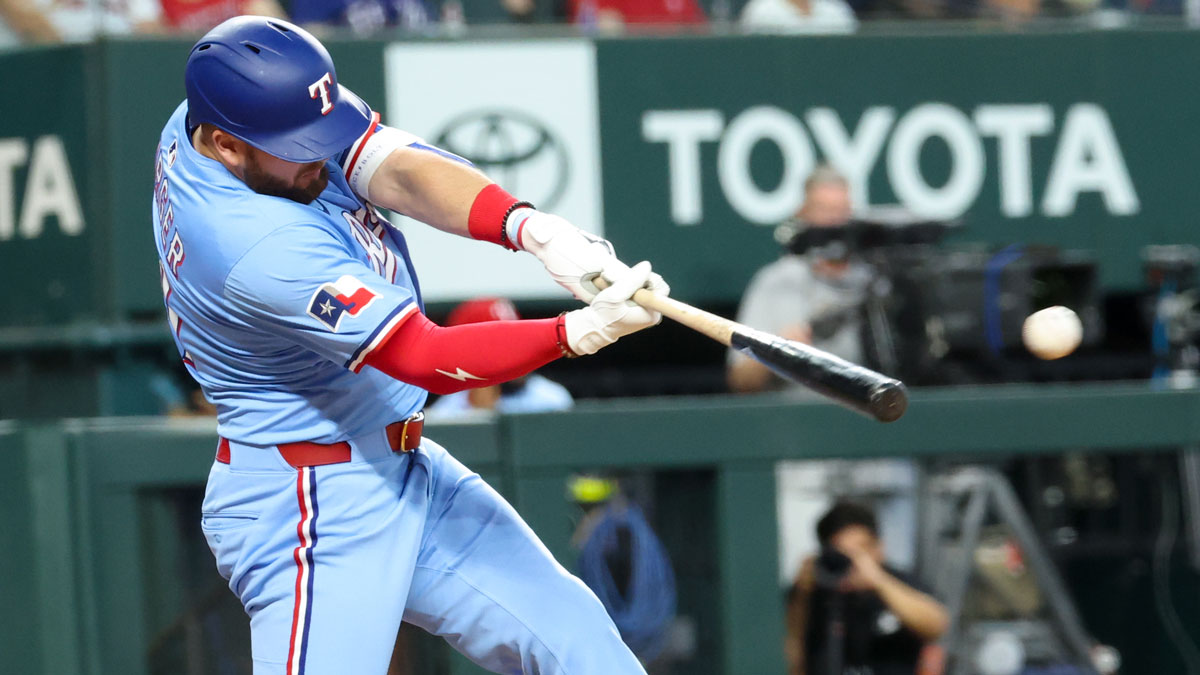 Jun 1, 2025; Arlington, Texas, USA; Texas Rangers designated hitter Jake Burger (21) hits an rbi double during the eighth inning against the St. Louis Cardinals at Globe Life Field.