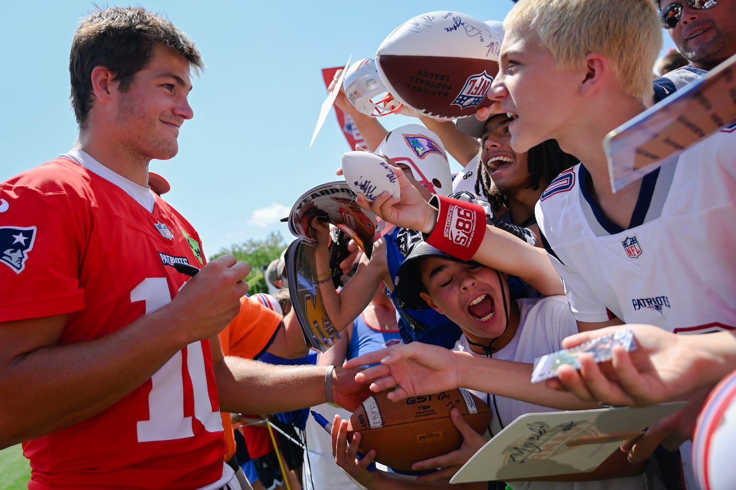 New England Patriots quarterback Drake Maye signed autographs for eager fans after day two of NFL training camp at Gillette Stadium on July 24.