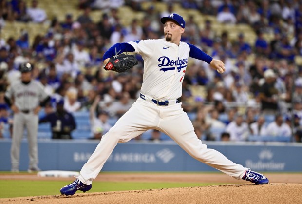 Dodgers starting pitcher Blake Snell throws to the plate during...